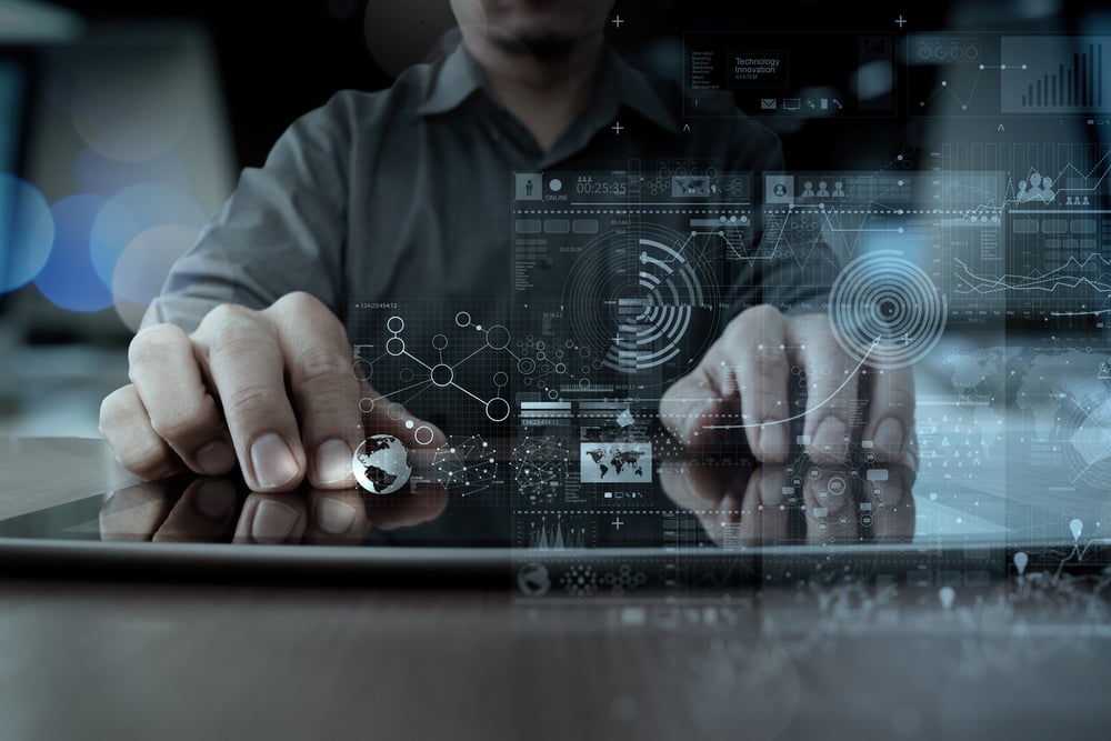 Businessman hand working with modern technology digital tablet computer and graphics layer effect as business strategy concept.